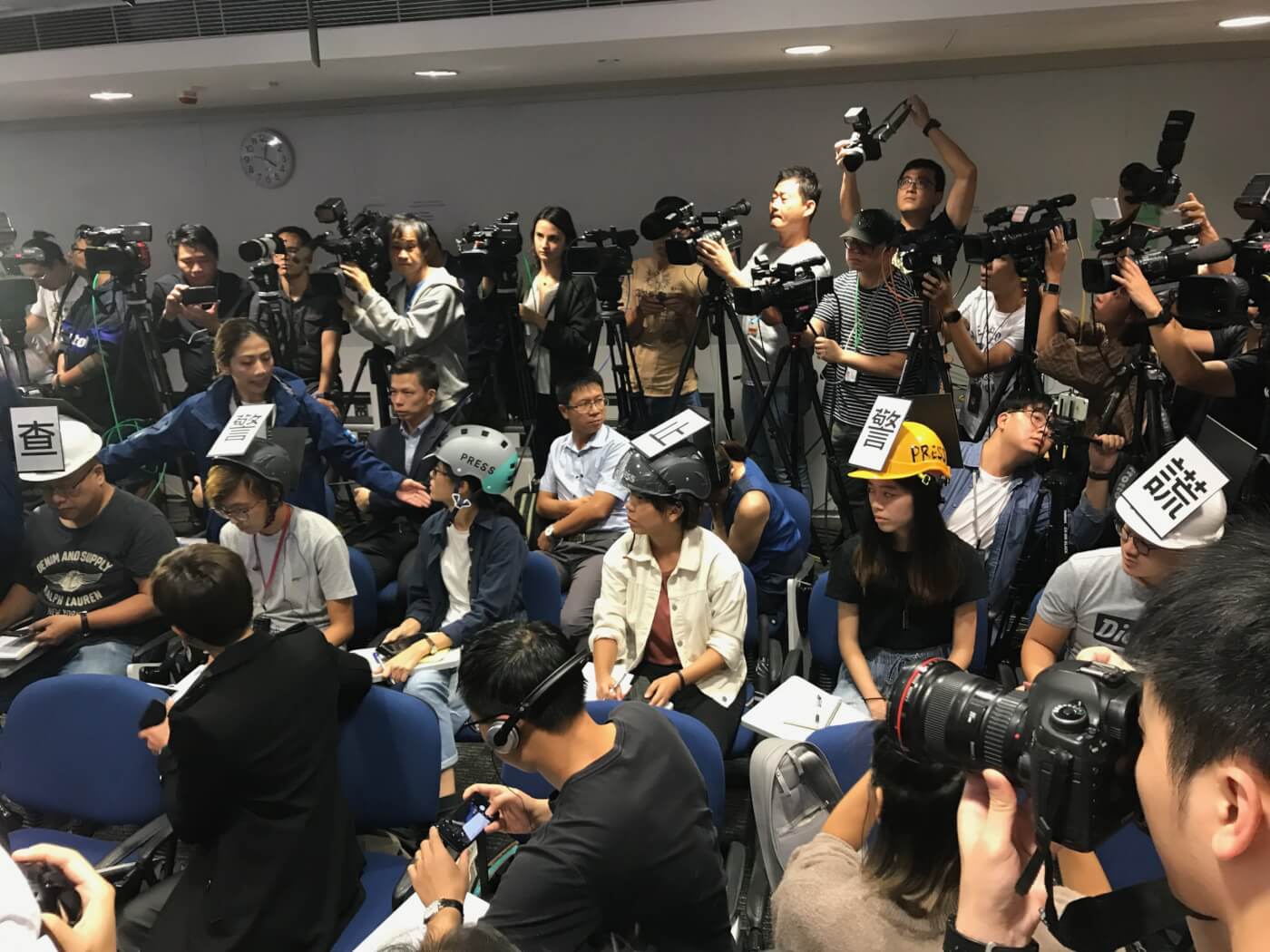 Hong Kong journalists stage protest at a press conference at police headquarters on November 4, 2019. The slogan on the protesters’ helmets reads “Investigate police violence, stop police lies”. Photo: Oliver Farry